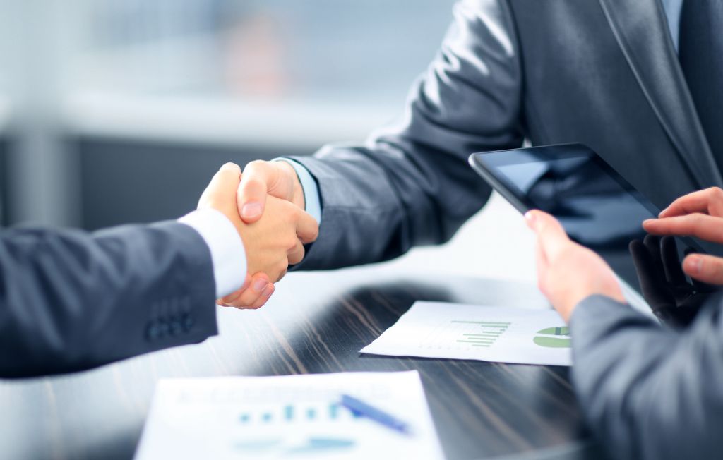Business people shaking hands in office - KSDT CPA