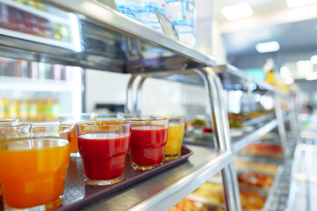 Colorful Array of Fruit Juice Cups on a Serving Cart in a Cafeteria - KSDT CPA
